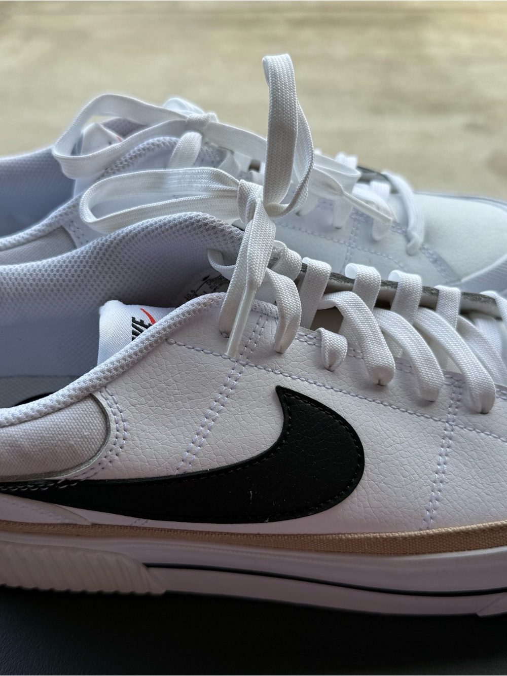 Nike Women’s White Sneakers with Black Swoosh and Tan Accent